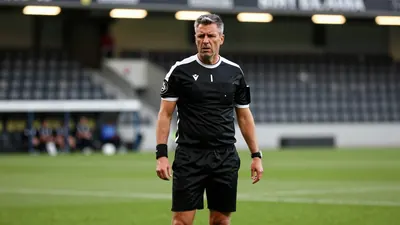 A 35-year-old Häcken coach, with a rugged build and graying temples, stands on the Bravida Arena pitchside, his face set...