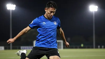 A 25-year-old male football player, wearing a blue and black kit